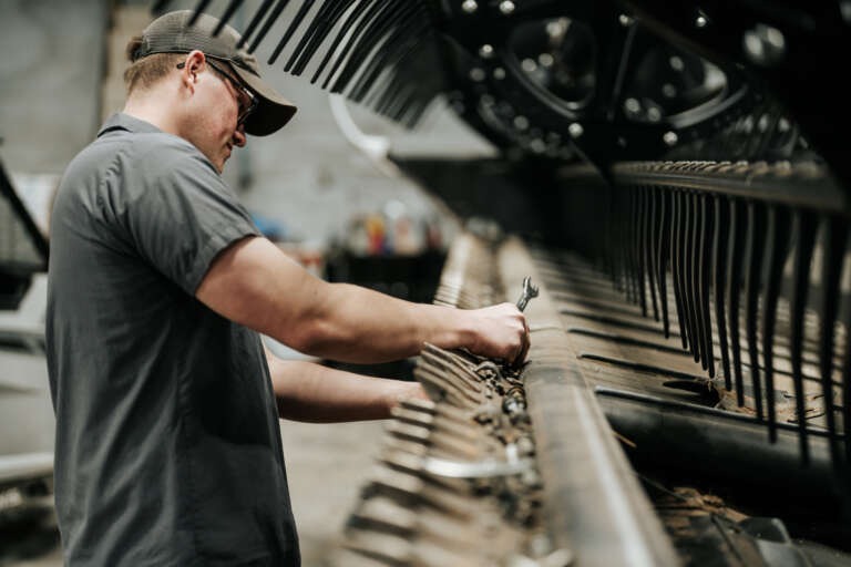 Working on a piece of grain processing equipment
